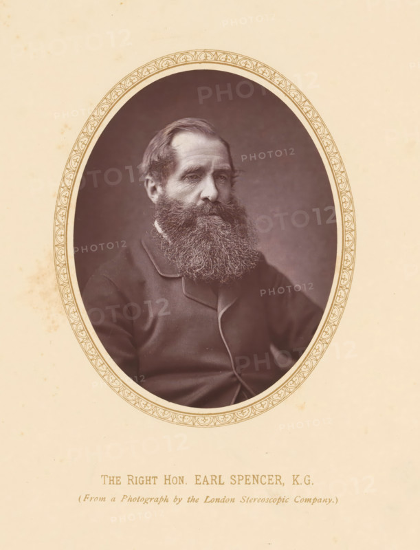 The right hon. Earl Spencer KG, page, photomechanical print, photographer: London Stereoscopic Company, London, c. 1875 - c. 1880, printmaker, paper, Woodburytype, height 108 mm x width 86 mm, Person, John Spencer (5th Earl Spencer), politician, eg party leader, A framed oval photograph of a man with a full beard and mustache, wearing a dark coat with visible lapels, set against a plain dark background, the oval frame having a decorative patterned border and mounted on a light-colored paper with faint stains.