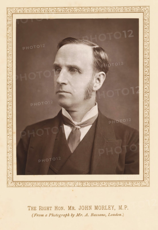 The right hon. Mr John Morley, MP, Portrait of John Morley, page, photomechanical print, photographer: Alexander Bassano, London, c. 1877 - c. 1882, printmaker, paper, Woodburytype, height 120 mm x width 94 mm, Person, John Morley, politician, eg party leader, A sepia-toned portrait of a man shown from the chest up within a decorative rectangular border, wearing a dark suit jacket and waistcoat with a high-collared shirt and a tied cravat, his hair neatly combed and short sideburns visible, his face turned slightly to one side with a neutral expression against a plain, softly shaded background.
