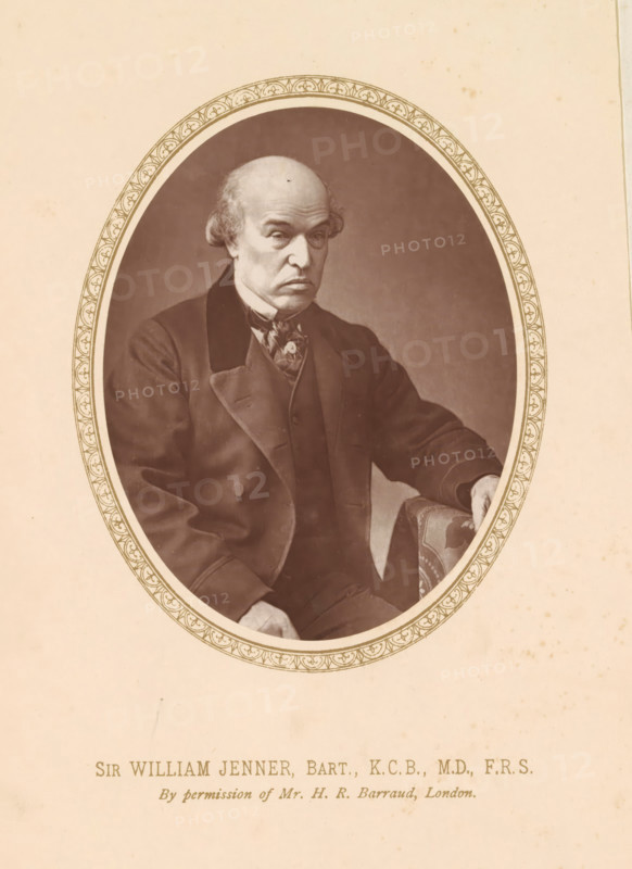 Sir William Jenner, Bart., KCB, MD, FRS, page, photomechanical print, photographer: Herbert Rose Barraud, London, c. 1876 - c. 1881, printmaker, paper, Woodburytype, height 111 mm x width 86 mm, Print on frontispiece., Person, William Jenner, physician, doctor, An oval sepia portrait shows an older man seated, wearing a dark suit with a high-collared shirt and a patterned neckerchief, his hair receding with wisps at the sides and a lined forehead, one hand resting on a patterned upholstered armrest and the other relaxed near his lap, the portrait framed by a decorative oval border set against a plain light background.
