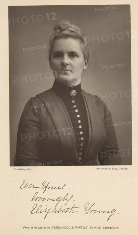 Portrait of Elizabeth Young, page, photomechanical print, inscription: 'Ever Yours. lovingly. Elizabeth Young', photographer: Greenwood & Hartley, maker: Waterman, c. 1882 - in or before 1892, paper, Woodburytype, height 117 mm x width 88 mm, Person, Elizabeth Young, adult woman, spreading the gospel, missionary work, A sepia portrait of a woman shown from the chest up against a plain backdrop, wearing a dark high-collared dress with a row of decorative buttons down the front and a brooch at the throat, her hair pulled back into a tidy updo, a calm neutral expression on her face, and a light border surrounding the image with a lighter area below that contains handwritten script.
