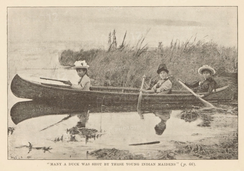 Many a duck was shot by these young indian maidens', Portrait of three Cree or Saulteaux women from Canada in a canoe, page, photomechanical print, inscription: '(p. 66).', Canada, maker: Waterlow & Sons Limited, c. 1882 - in or before 1892, Waterlow & Sons Limited, photographer, North America, paper, autotypie, height 98 mm x width 148 mm, rowing-boat, canoe, canoeing, human races, peoples, nationalities, Native peoples of the Americas, original inhabitants of North America, A grainy monochrome image shows three people seated in a long wooden canoe on calm water near tall grasses and reeds; each person wears a hat and holds a paddle, and their reflections are visible on the water surface, while the canoe appears close to the grassy shoreline and the background is mostly open sky and vegetation.