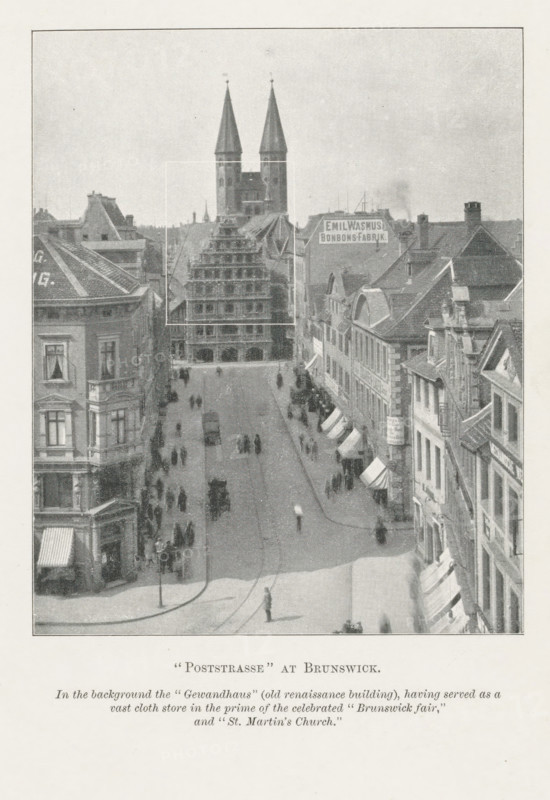 Poststrasse' at Brunswick, page, photomechanical print, inscription: 'In the background, 'St. Martin's Church.'', Braunschweig, c. 1889 - in or before 1899, photographer, printmaker, Lower Saxony, paper, autotypie, height 119 mm x width 96 mm, city-view in general, 'veduta', street, A wide street scene viewed from above showing a straight avenue lined with multi-story buildings on both sides and a large stepped gabled building and a twin-spired church tower rising behind it at the far end; people walk along the sidewalks and in the roadway, with several horse-drawn carriages and a few solitary figures visible; awnings extend over some ground-floor shopfronts on the right side, and buildings display varied rooflines, chimneys, and ornate facades; a lamppost stands near the foreground at the street corner and the scene is presented in a monochrome, grainy photographic style.