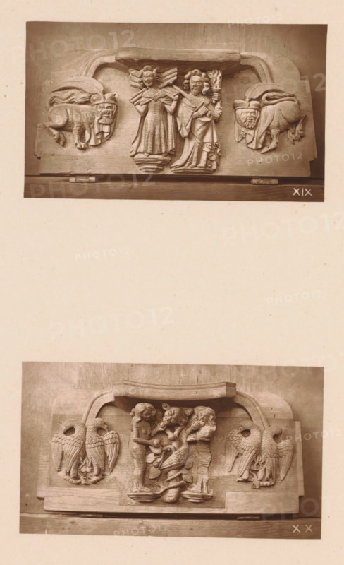 Two woodcarvings in Worcester Cathedral, page, photomechanical print, Above a woman and a man with a sword and torch between two fantastical creatures, below Adam and Eve eating from the tree of knowledge of good and evil among four birds., number: 'XIX, XX', c. 1863 - in or before 1873, paper, Woodburytype, Woodburytypie, height 306 mm x width 244 mm, interior of church, fabulous animals (sometimes wrongly called 'grotesques'), 'Mostri' (Ripa), Adam and Eve holding (and possibly eating) the fruit, carving, applied arts, A sepia-toned photograph shows two horizontal carved wooden panels mounted on a lighter background, each panel featuring raised sculptural reliefs. The top panel depicts two standing human figures in robes at its center, the left figure with wings behind and hands raised, the right figure holding a torch-like object and a staff, flanked on each side by stylized animal heads with curled bodies that face inward. The lower panel shows a central scene of two smaller human ...