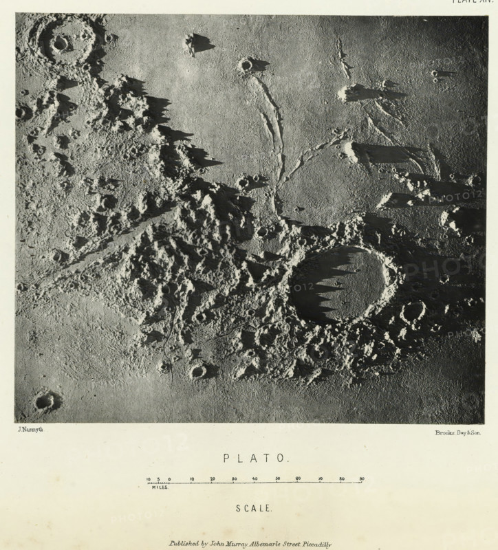 Plato, page, photomechanical print, name: 'Published by John Murray, Albemarle Street, Piccadilly.', number: 'Plate XIV.', inscription: 'Scale.', photographer: James Nasmyth, United Kingdom, cliché maker: anonymous, printer (person): Vincent Brooks, Day & Son, publisher: John Murray, London, c. 1870 - in or before 1873, printer (person), paper, Woodburytype, height 128 mm x width 147 mm, Print for page 121., surface of the moon, Moon, A high-contrast black and white aerial view showing a rough, cratered surface with varied textures and shadows; rugged mountainous ridges and jagged peaks cast elongated dark shadows across a flatter plain, where circular depressions with raised rims are visible and one large round basin displays a series of pointed shadowed formations along its inner edge; narrow sinuous channels or grooves run across the terrain linking several craters; areas of smooth, gently shaded surface contrast with densely pitted, rocky regions covered in small hollows and irregu...