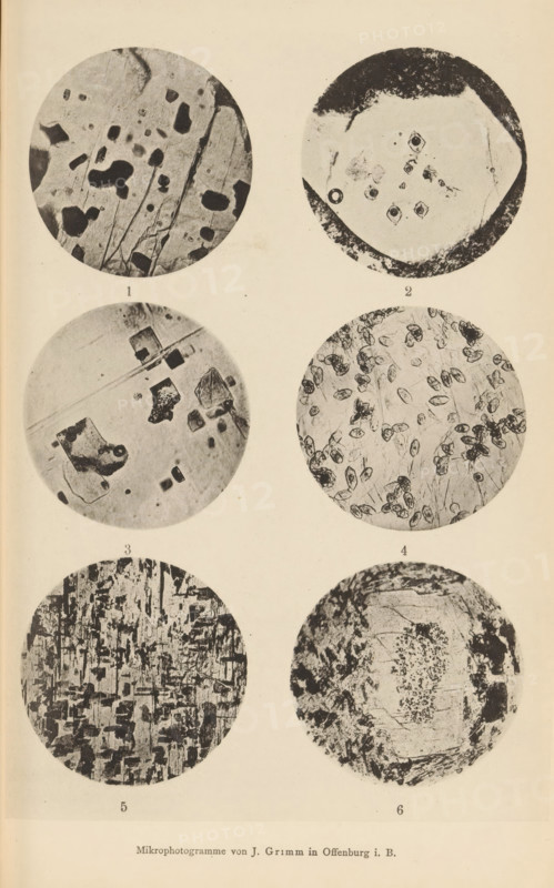 Six microscopic enlargements of minerals, page, photomechanical print, Image 1 is labradorite, 2 is quartz, 3 is oligoclase, 4 is heulandite, 5 is hypersthene and 6 is feldspar and trachyte., number: '1, 6', number: 'Tafel VII', photographer: Emil Cohen, Greifswald, cliché maker: J. Grimm, Offenburg, c. 1880 - in or before 1885, Baden-Württemberg, Mecklenburg-Vorpommern, paper, collotype, photoprint, height 233 mm x width 149 mm, minerals and metals, A vertical sheet with six circular black-and-white photographic discs arranged in three rows and two columns, each disc showing different textured microscopic patterns; the top left disc contains irregular dark blotches and thin linear scratches on a lighter background, the top right disc shows a paler central area with darker irregular rim and small clustered dark shapes near the center, the middle left disc displays angular dark fragments and faint diagonal streaks on a lighter field, the middle right disc is filled with numerous small o...