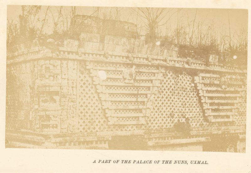 A part of the palace of the nuns, Uxmal, photograph, page, c. 1870 - in or before 1880, photographer, North America, paper, albumen print, height 91 mm x width 151 mm, ruin of a dwelling, house, castle, palace, A faded photograph of a stone structure with a patterned facade composed of lattice-like blocks and horizontal stone slabs, showing carved decorative elements along one corner and layered masonry at the base, with sparse vegetation and thin tree trunks rising behind the structure and a pale circular blemish on the surface of the image.