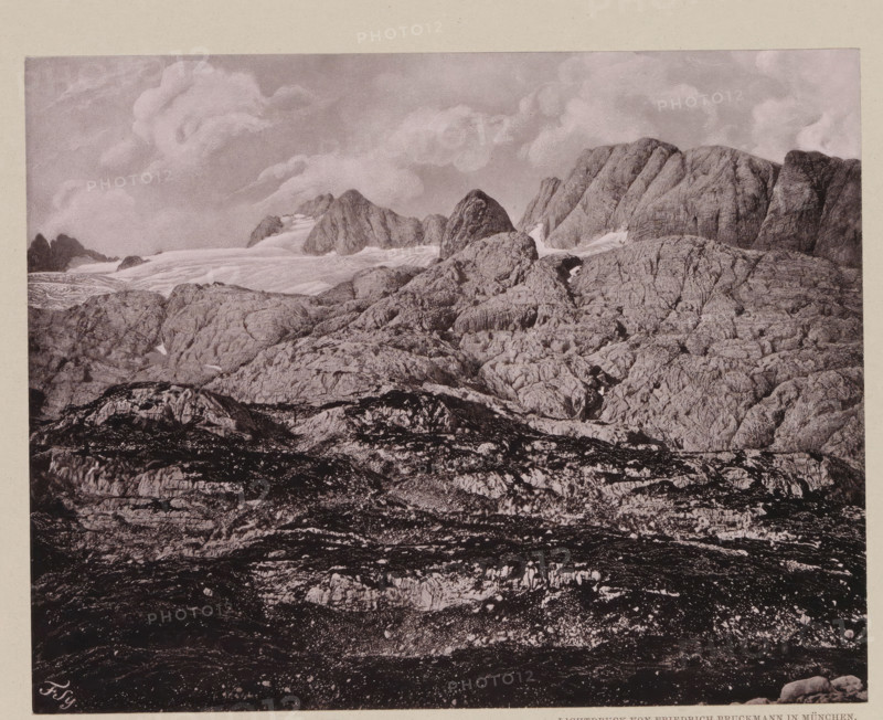 Das Carls-Eisfeld von der Ochsenwieshöhe, View of the Hallstätter Glacier, page, photomechanical print, number: 'VIII.', photographer: Friedrich Simony, Salzburg (city), cliché maker: Friedrich Bruckmann, Vienna, publisher: Eduard Hölzel, c. 1879 - in or before 1889, Lower Austria, paper, collotype, photoprint, height 147 mm x width 187 mm, glacier, Hallstätter Gletscher, A monochrome landscape showing layered rocky terrain rising toward jagged mountain peaks, with textured rock faces and crevices in the foreground and midground, patches of lighter smooth surfaces suggesting snow or ice tucked between ridges, and a sky filled with soft, billowing clouds above the peaks.