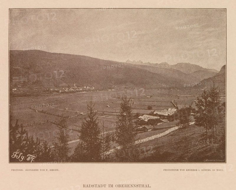 Radstadt im Oberennsthal, View of Radstadt, page, photomechanical print, number: 'XVI.', photographer: Friedrich Simony, Austria, cliché maker: Angerer & Göschl, C., Vienna, publisher: Eduard Hölzel, 1887, Lower Austria, paper, autotypie, height 140 mm x width 195 mm, city-view in general, 'veduta', Salzburg (city), Radstadt, A sepia-toned landscape photograph shows a wide valley with fields and scattered buildings, framed by distant mountains under a pale sky; trees and darker vegetation appear in the foreground, and a small cluster of structures including a tall steeple is visible near the valley center.