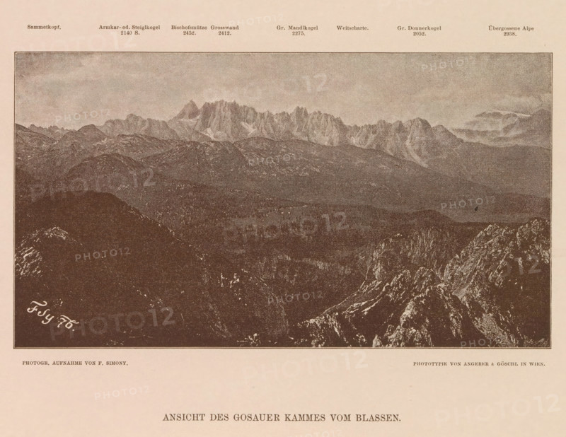 Ansicht des Gosauer Kammes vom Blassen, View of the Gosaukamm, page, photomechanical print, number: 'XIX.', photographer: Friedrich Simony, Salzburg (city), cliché maker: Angerer & Göschl, C., Vienna, publisher: Eduard Hölzel, 1876, Lower Austria, paper, autotypie, height 120 mm x width 217 mm, city-view in general, 'veduta', Dachstein (Salzburg), Gosaukamm, A sepia-toned panoramic image of a mountain range with jagged peaks rising in the background above rolling, rocky foothills and forested slopes, framed by a dark foreground of rugged rock formations and cliffs, with a pale sky occupying the upper area.