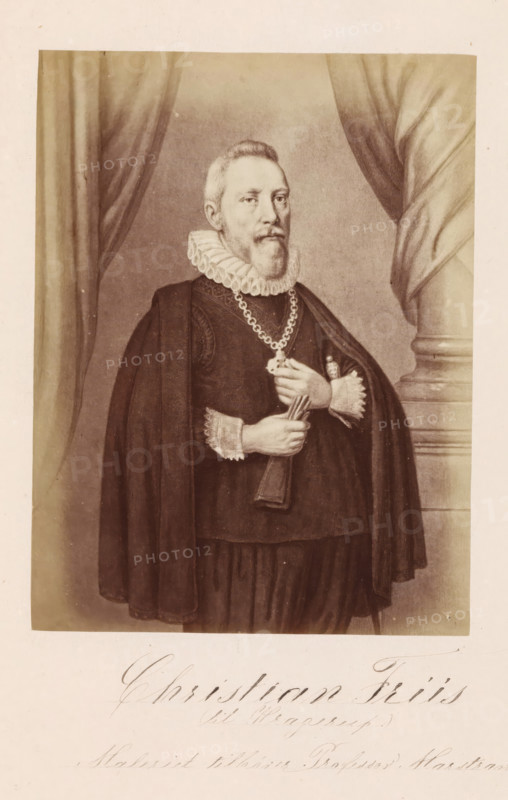 Photo reproduction of a painting depicting a portrait of Christian Friis til Kragerup, Christian Friis (til Kragerup), photograph, reproduction, page, inscription: 'Maleriet tillhører Professor Marstrand.', photographer: Julius Wulff, after painting by anonymous, c. 1858 - in or before 1862, paper, albumen print, height 163 mm x width 125 mm, Person, Christian Friis til Kragerup, official, civil servant, functionary (in general), A sepia-toned portrait of a man standing in front of draped curtains and a column, wearing dark formal robes with a cape and a ruffled collar, a chain with a medallion around his neck, and lace cuffs; he has a short beard and mustache and is holding a folded document or fan in his hands while looking slightly to the side.