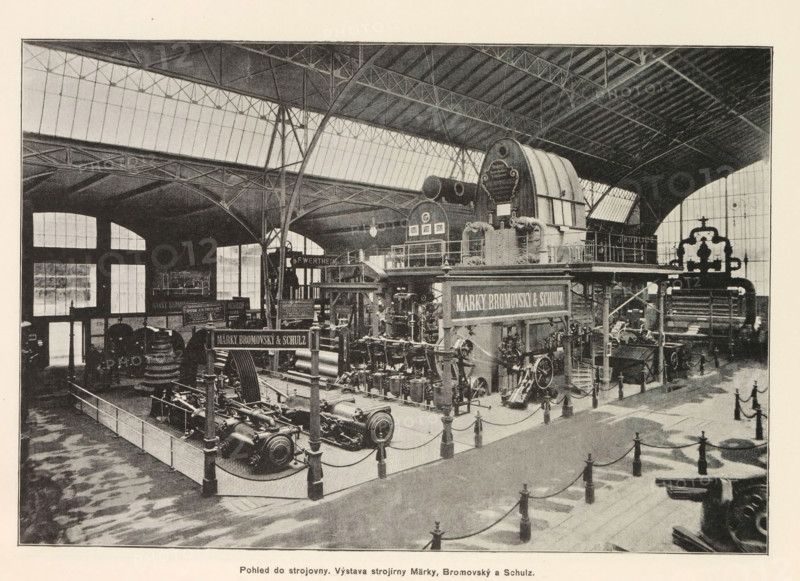 Interior of an engine room with an exhibition by Marek, Bromovský and Schulz, Pohled do strojovny. Výstava strojirny Marky, Bromovský a Schulz, page, photomechanical print, Prague, cliché maker: Carl Bellmann, c. 1890 - in or before 1895, photographer, paper, autotypie, height 176 mm x width 258 mm, interior, representation of a building, machines, parts of machines, tools and appliances, A large interior space with a high arched roof supported by metal trusses and tall windows along the upper walls, containing an exhibition of heavy industrial machinery arranged on raised platforms and behind low railings, including large cylindrical and gear-like components, pumps, valves, and interconnected pipes, with a prominent arched machine housing on a raised platform and multiple signs mounted above equipment, walkways and stair railings around the displays, scattered freestanding posts connected by ropes marking a pedestrian path, shadowed floor patterns, and a few small human figures near t...