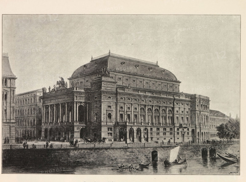 Perspektivni pohled na Národni divadlo v Praze, Photo reproduction of a drawing depicting an exterior of the National Theater in Prague, reproduction, page, photomechanical print, Prague, cliché maker: Carl Bellmann, after drawing by anonymous, c. 1891 - in or before 1895, photographer, paper, autotypie, height 180 mm x width 263 mm, façade (of house or building), theater (building), National Theater, A detailed monochrome illustration of a large ornate building with a tall mansard roof and decorative balustrades, featuring a grand façade with columns, arched openings on the ground level, rows of rectangular windows, sculptural figures along the roofline and at corners, and intricate stonework and friezes; the building sits beside a riverside embankment with a stone wall and arched openings at water level, small boats and rowboats on the water with figures aboard, horse-drawn carriages and pedestrians on the promenade, and distant trees and adjacent multi-story buildings extending alon...
