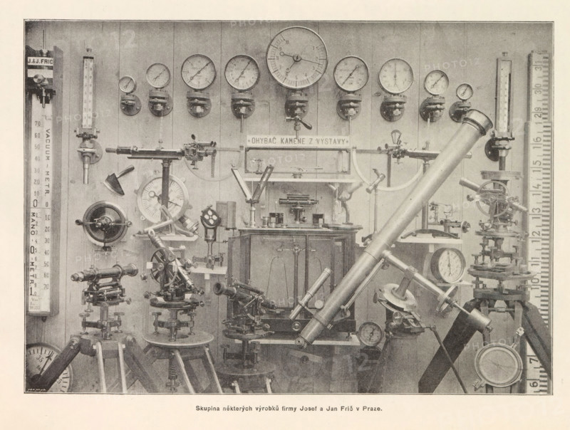 Skupina nekterých výrobku firmy Josef a Jan Fric v Praze, Telescopes and meters of Josef and Jan Fric in Prague, page, photomechanical print, Prague, cliché maker: Carl Bellmann, c. 1891 - in or before 1895, photographer, paper, autotype, height 180 mm x width 253 mm, telescope, A sepia-toned photograph of a wall filled with scientific instruments and gauges, featuring a row of round dials mounted near the top, vertical glass tube meters on either side, and a large angled telescope-like tube crossing the foreground; below the dials and meters are various metal stands, precision adjustment mechanisms, circular pressure gauges, and articulated arms, all arranged with clamps, knobs, and graduated faces, with several tripod-mounted devices and flat-topped cabinets visible toward the center and lower area.
