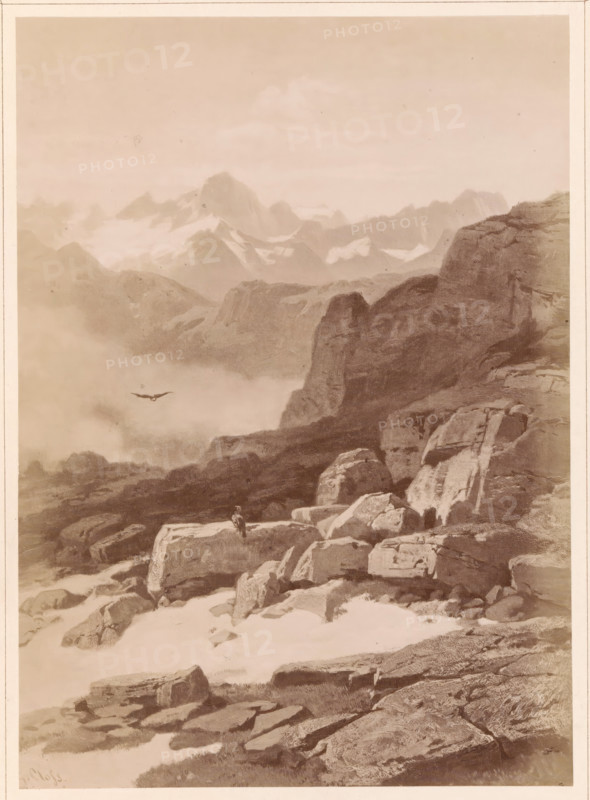 Photo reproduction of a painting of a view from the Furka Pass to the Finsteraarhorn, Auf der Furka. Gegen das Finsteraarhorn gesehen, photograph, reproduction, page, number: '10.', publisher: Friedrich Bruckmann, after painting by Gustav Paul Closs, c. 1863 - in or before 1873, photographer, paper, albumen print, height 202 mm x width 144 mm, mountain-range, snow peaks, predatory birds, Alps, Bernese Alps, Furka pass, Finsteraarhorn, A sepia-toned mountain landscape showing layered rocky cliffs and boulders in the foreground and middle distance, with a high, sheer rock face on the right and rugged peaks and snowfields fading into mist in the background; a lone bird is visible in flight above the misty valley and a small solitary figure stands atop a large foreground rock, while patches of snow and scattered stones cover the ground.