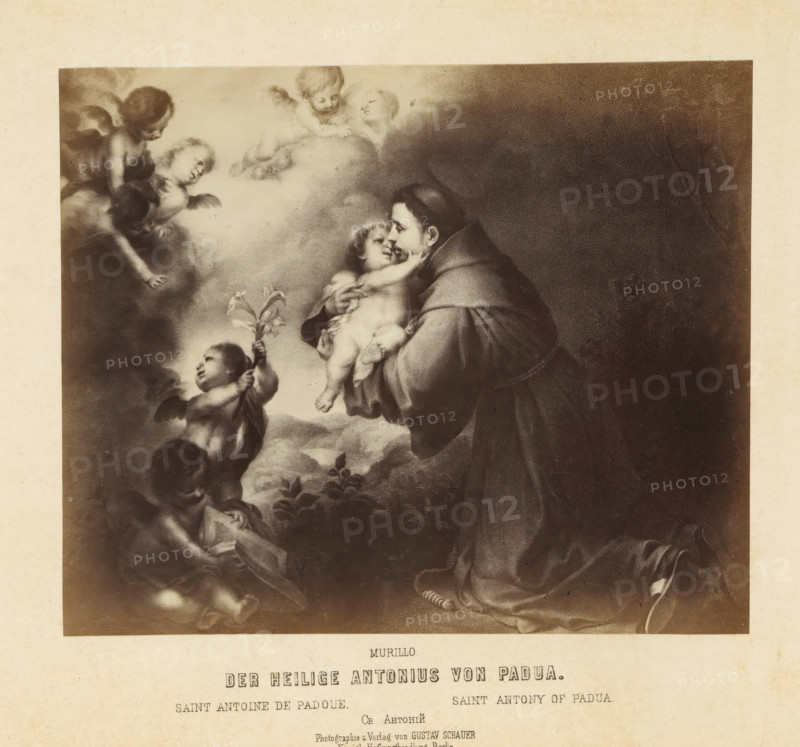 Photo reproduction of a print after a painting by Anthony of Padua with a child by Bartolomé Esteban Murillo, Der saint Antonius von Padua, photograph, reproduction, page, number: '114.', photographer: Gustav Schauer, Berlin, after print by anonymous, after painting by Bartolomé Esteban Murillo, c. 1850 - in or before 1860, after print by, paper, albumen print, albumendruk, height 137 mm x width 166 mm, the Franciscan monk Antony of Padua, possible attributes: ass, book, crucifix, flowered cross, flaming heart, infant Christ (on book), lily, A sepia-toned classical painting shows a robed man kneeling while holding a small child against his chest, the man's face turned toward the child's face and the child reaching up; surrounding them are several cherubic children with wings floating on clouds, one cherub holds a stem with flowers and others gesture or look toward the central figures; the scene is bordered by a light paper margin and the lower portion of the image shows the edge of the...