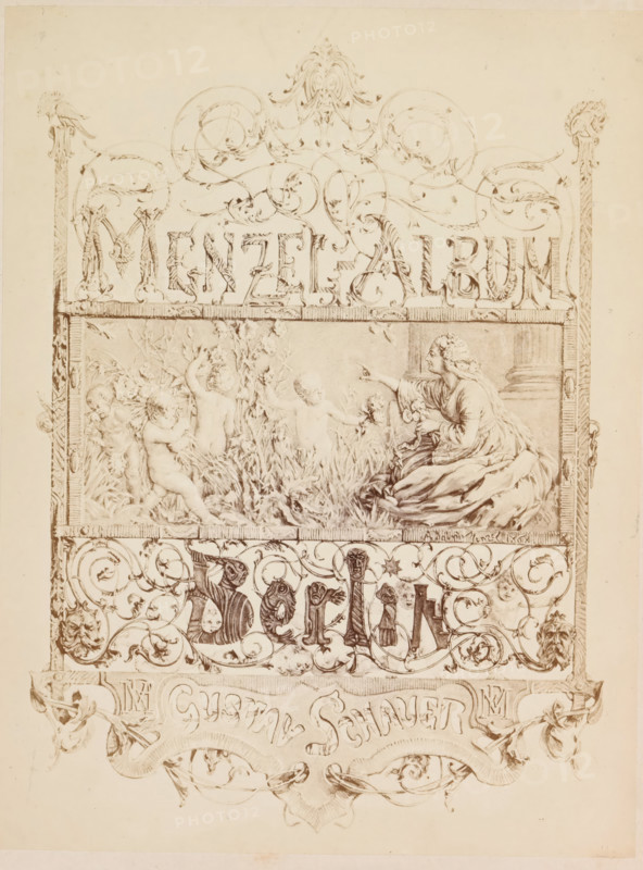 Photographic reproduction of a drawing for a book with photographic reproductions of paintings by Adolf Menzel, Menzel Album Berlin, photograph, reproduction, page, photographer: Gustav Schauer, Berlin, after drawing by anonymous, c. 1858 - in or before 1868, paper, albumen print, height 266 mm x width 202 mm, book in which illustrations are essential, A vertical sepia-toned illustration with ornate decorative borders and scrolling motifs framing a central rectangular scene that shows a seated woman in a flowing gown on the right reaching toward a group of naked children playing among tall grasses and flowers on the left; above the central scene there is an elaborate header of swirling ornamental flourishes and stylized foliage, and below it a band of dense scrollwork populated with small carved faces and whimsical figures integrated into the curving patterns; the edges of the page show carved column-like vertical borders and corner details, and the lower portion contains a ribbon-like...