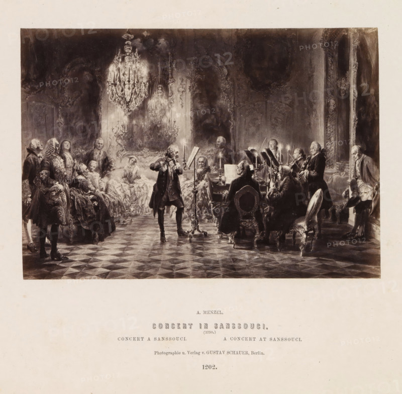 Concert in Sanssouci, Photographic reproduction of a painting of a concert in Sanssouci Palace by Adolf Menzel, photograph, reproduction, page, number: '1202.', photographer: Gustav Schauer, Berlin, after painting by Adolph Menzel, c. 1858 - in or before 1868, paper, albumen print, height 122 mm x width 175 mm, more than one musician with instrument, palace, Potsdam, Sanssouci, A sepia-toned scene shows a grand interior with a patterned floor and ornate walls, a large chandelier hanging from the ceiling, and a group of well-dressed figures gathered around musicians; one central figure stands playing a flute in front of a music stand with candles, seated musicians play string and keyboard instruments, and seated and standing listeners in formal attire watch from chairs and sofas arranged along the sides, with decorative mirrors or panels and tall windows visible in the background.