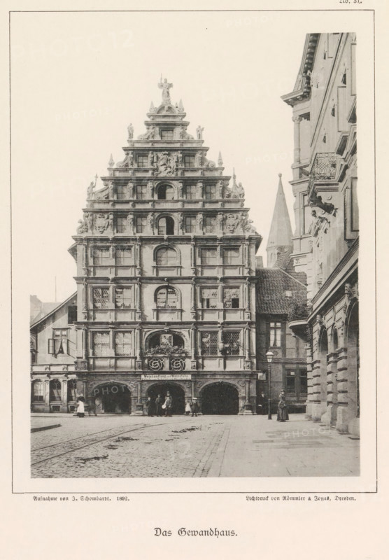 Das Gewandhaus, Front facade of the Gewandhaus in Braunschweig, Braunschweig's Baudenkmäler, page, photomechanical print, number: 'No. 31.', photographer: J. Schombardt, Braunschweig, cliché maker: Römmler & Jonas, Dresden, publisher: Benno und Wilhelm Danert Goeritz, 1892, J. Schombardt, Römmler & Jonas, Benno und Wilhelm Danert Goeritz, photographer, cliché maker, publisher, Lower Saxony, Saxony, paper, collotype, photoprint, height 153 mm x width 112 mm, facade (of house or building), guildhall, Gewandhaus, A tall multi-tiered ornate building façade fills the left and center of the image, featuring stacked horizontal layers with decorative window surrounds, sculpted figures, and ornamental reliefs; the ground level has three large arched openings with people standing and walking nearby, and a cobblestone street extends in front. To the right a narrower street is flanked by another elaborately detailed building with balconies, columns, and carved stonework, and a few more people stan...