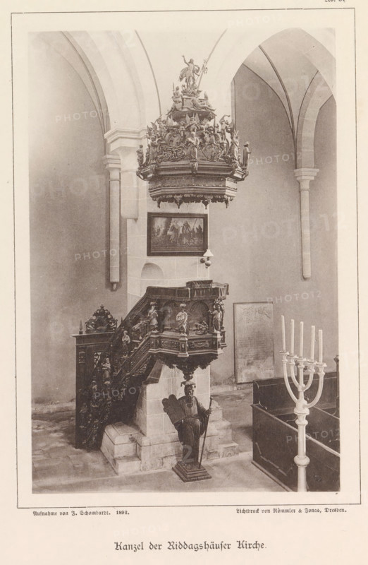 Pulpit of the Riddagshausen Abbey in Braunschweig, Kanzel der Riddagshäuser Kirche, Braunschweig's Baudenkmäler, page, photomechanical print, number: 'No. 34.', photographer: J. Schombardt, Riddagshausen Abbey, cliché maker: Römmler & Jonas, Dresden, publisher: Benno und Wilhelm Danert Goeritz, Braunschweig, 1892, J. Schombardt, Römmler & Jonas, Benno und Wilhelm Danert Goeritz, photographer, cliché maker, publisher, Lower Saxony, Saxony, paper, collotype, photoprint, height 158 mm x width 106 mm, pulpit, ambo, chancel, abbey, monastery, convent, Roman Catholic church, An interior scene showing a carved wooden pulpit with ornate reliefs and statues, elevated on a stone base with a staircase leading up, a tall decorative canopy with sculpted figures suspended above it, a standing carved figure holding a staff positioned at the base, a framed painting mounted on the wall behind the pulpit, tall arched stone columns and vaulting in the background, a multi-branched candelabrum in the foreg...