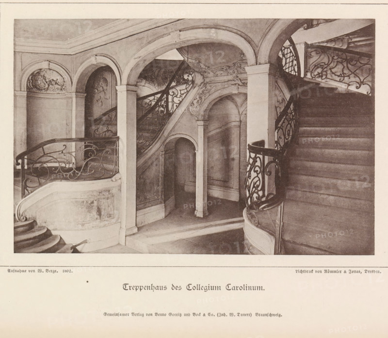 Treppenhaus des Collegium Carolinum, Stairwell of the Collegium Carolinum in Braunschweig, Braunschweig's Baudenkmäler, page, photomechanical print, number: 'No. 36.', photographer: J. Schombardt, Collegium Carolinum, cliché maker: Römmler & Jonas, Dresden, publisher: Benno und Wilhelm Danert Goeritz, Braunschweig, 1892, J. Schombardt, Römmler & Jonas, Benno und Wilhelm Danert Goeritz, photographer, cliché maker, publisher, Lower Saxony, Saxony, paper, collotype, photoprint, height 105 mm x width 159 mm, staircase, A sepia-toned photograph of an interior stairhall with curved stone staircases and ornate wrought-iron railings, showing a sweeping staircase on the right ascending out of frame and a curved balustrade on the left, framed by rounded arches and pilasters with decorative plasterwork and relief motifs, shadowed wall recesses and an arched doorway beneath the stairs, marble or stone steps and landings, and intricate scrollwork on the metal railings.
