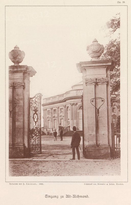 Eingang zu Alt-Richmond, Entrance gate of the Castle Richmond in Braunschweig, Braunschweig's Baudenkmäler, page, photomechanical print, number: 'No. 38.', photographer: J. Schombardt, Braunschweig, cliché maker: Römmler & Jonas, Dresden, publisher: Benno und Wilhelm Danert Goeritz, 1892, J. Schombardt, Römmler & Jonas, Benno und Wilhelm Danert Goeritz, photographer, cliché maker, publisher, Lower Saxony, Saxony, paper, collotype, photoprint, height 157 mm x width 105 mm, fence, wall, eel, castle, Schloss Richmond, A sepia-toned view through a large ornate wrought-iron gate flanked by tall stone pillars topped with decorative urns, showing a classical building with tall windows, decorative cornices, and a curved central section; a few people in period clothing stand near the building and in the foreground a man with a hat and cane faces the gate; trees are visible to the right and paving stones cover the ground.
