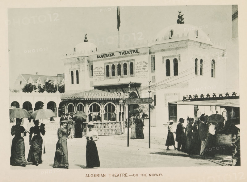Algerian theatre-on the Midway, View of a theatre at Algeria's participation in the World's Columbian Exposition in Chicago in 1893, page, photomechanical print, number: 'Plate 106', photographer: Charles Dudley Arnold, Chicago, photographer: HD Higinbotham, clichémaker: anonymous, 1893, North America, Illinois, paper, collotype, photogravure, height 133 mm x width 190 mm, theatre (building), world fair, world exhibition, World's Columbian Exposition, A street scene in front of a large ornate building with domed roofs and arched windows, featuring decorative patterned facades and a flagpole extending upward from the roof. A smaller pavilion with scalloped arches and intricate latticework sits near the building, and a freestanding signpost stands beside it. Groups of people in period clothing are gathered in the foreground and near the pavilion; several women hold parasols and wear long dresses and hats, while other figures wear suits and hats, some clustered around a covered stall with...