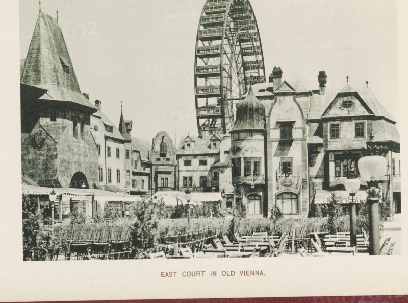 East court in old Vienna, View of a square with replicas of historic buildings at the World's Columbian Exposition in Chicago in 1893, page, photomechanical print, number: 'Plate 109', photographer: Charles Dudley Arnold, Chicago, photographer: HD Higinbotham, cliché maker: anonymous, 1893, Charles Dudley Arnold, HD Higinbotham, photographer, cliché maker, North America, Illinois, paper, collotype, photoprint, height 133 mm x width 191 mm, world fair, world exhibition, World's Columbian Exposition, A black and white scene of a European-style courtyard with rows of wooden chairs in the foreground and a variety of ornate buildings behind them, featuring steep roofs, turrets, arched windows, decorative façades, and a rounded tower with a conical roof; a large Ferris wheel rises behind the buildings, showing its spokes and passenger platforms; awnings and storefronts line the ground level beneath the buildings, and a lamp post with a rounded top stands on the right side of the image.
