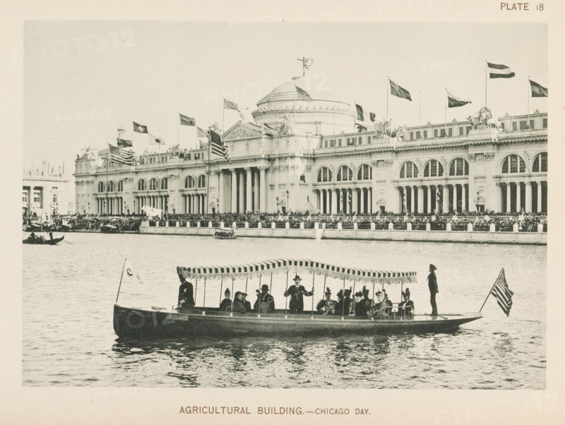 View of the agricultural building, designed by Charles McKim at the World's Columbian Exposition in Chicago in 1893, Agricultural Building.- Chicago day, page, photomechanical print, number: 'Plate 18', photographer: Charles Dudley Arnold, Chicago, photographer: HD Higinbotham, cliché maker: anonymous, 1893, Charles Dudley Arnold, HD Higinbotham, photographer, cliché maker, North America, Illinois, paper, collotype, photoprint, height 133 mm x width 190 mm, rowing-boat, canoe, pond, pool, world fair, world exhibition, World's Columbian Exposition, A wide waterfront scene shows a large classical building with a domed central section and a long colonnaded facade adorned with sculptures and statues along its roofline, many flags flying from poles above the roof, and arched windows and decorative cornices; in front of the building a crowd lines a raised promenade and boats are on the water, including a foreground motor launch with a striped canopy carrying several seated and standing passe...
