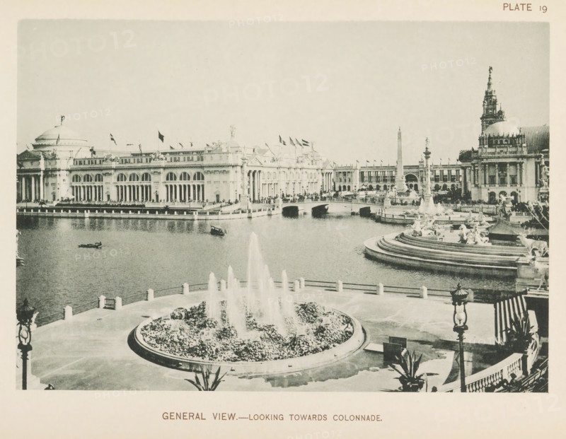 General view.- Looking towards colonnade, View of the central square of the World's Columbian Exposition in Chicago in 1893, page, photomechanical print, number: 'Plate 19', photographer: Charles Dudley Arnold, Chicago, photographer: HD Higinbotham, cliché maker: anonymous, 1893, Charles Dudley Arnold, HD Higinbotham, photographer, clichémaker, North America, Illinois, paper, collotype, photoprint, height 133 mm x width 190 mm, ornamental fountain, pond, pool, world fair, world exhibition, World's Columbian Exposition, A wide view of a formal waterside plaza with a large circular fountain in the foreground spraying tall jets of water from a planted basin, a curved balustraded terrace surrounding stepped water basins and sculptural figures along the right side, and a broad ornamental pool extending toward a classical colonnaded building with arched windows and a domed roof on the left; a bridge with arches crosses the water toward the center, flanked by tall columnar monuments and addit...