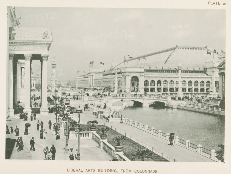 Liberal Arts Building, from colonnade, View of the building for technology and liberal arts at the World's Columbian Exposition in Chicago in 1893, page, photomechanical print, number: 'Plate 21', photographer: Charles Dudley Arnold, Chicago, photographer: HD Higinbotham, clichémaker: anonymous, 1893, Charles Dudley Arnold, HD Higinbotham, photographer, clichémaker, North America, Illinois, paper, collotype, photogravure, height 134 mm x width 191 mm, world fair, world exhibition, World's Columbian Exposition, A wide view of a waterfront scene with a large classical building featuring tall columns and arched windows, ornate cornices, and a sloped roof with flagpoles; a broad promenade lined with lampposts, potted plants, and balustrades runs alongside the water where a stone bridge with sculptural figures spans the channel; numerous people in period clothing walk along the promenade and gather near the colonnade, some holding umbrellas; decorative statues and columns punctuate the open...
