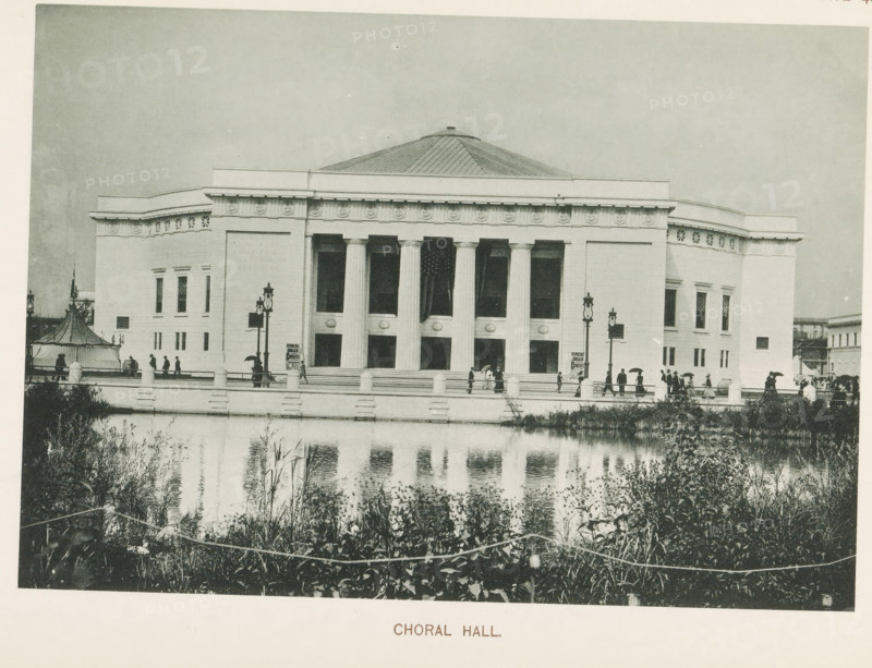 Choral Hall, View of a concert hall at the World's Columbian Exposition in Chicago in 1893, page, photomechanical print, number: 'Plate 42', photographer: Charles Dudley Arnold, Chicago, photographer: HD Higinbotham, cliché maker: anonymous, 1893, Charles Dudley Arnold, HD Higinbotham, photographer, cliché maker, North America, Illinois, paper, collotype, photoprint, height 134 mm x width 191 mm, world fair, world exhibition, concert hall, World's Columbian Exposition, A large classical building with a domed roof and a colonnaded front stands behind a low balustrade bordering a reflecting pool; the facade shows tall rectangular openings between fluted columns, decorative frieze elements along the roofline, and symmetrically placed windows on the side wings; people with umbrellas and hats walk along the terrace and steps in front of the building, and ornate street lamps rise near the entrance; vegetation and reeds grow along the near bank of the pool, and the water reflects the building...