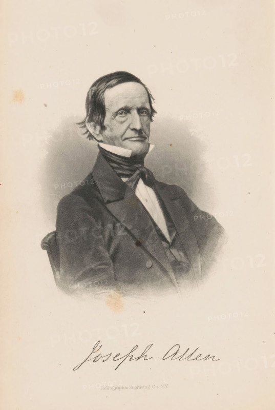 Joseph Allen, Portrait of Joseph Allen, page, photomechanical print, cliché maker: Heliographic Engraving Co., New York (city), c. 1864 - in or before 1869, photographer, North America, paper, collotype, photoprint, height 97 mm x width 75 mm, Print opposite title page., Person, historical persons, A black and white engraved portrait of a seated man shown from the waist up wearing a dark suit jacket with wide lapels, a vest, a high white collar, and a dark cravat tied at the neck, his hair dark and combed back with slight waves, his face long with pronounced cheekbones and a neutral expression, the background shaded around the figure fading into a lighter plain area, and some small stains and spots visible on the paper.