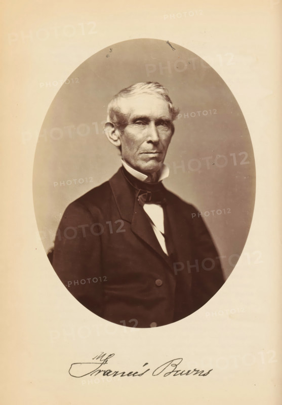 Francis Burns, Portrait of Francis Burns, photograph, page, photographer: Bendann Bros., c. 1866 - in or before 1871, paper, albumen print, height 148 mm x width 114 mm, Person, historical persons, An oval sepia-toned portrait of an older man shown from the waist up, wearing a dark coat with a high collar, a white shirt, and a bow tie, with short light-colored hair combed to the side, prominent ears, and a serious facial expression, set against a plain lighter background within a rectangular page.