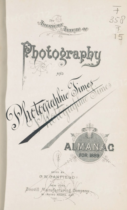 The American annual of photography and photographic times almanac for 1889, book, editor (person who revises): CW Canfield, publisher: Scovill Manufacturing Company, New York (city), 1889, editor (person who revises), North America, textile materials, paper, linen (material), printing, photochemical processes, photoaquatint, autotype, daylight gelatin silver print, gelatin silver print, collotype, developing gelatin silver print, height 231 mm x width 155 mm x thickness 31 mm, A vertical page with ornate decorative lettering and swirling embellishments arranged in a formal title layout, featuring a large stylized word near the top with elaborate flourishes and textured fill, a diagonal calligraphic phrase slanted across the center with a bold sweeping stroke beneath it and faint overlapping shadowing, a circular ornamental emblem toward the lower right with decorative scrollwork and a textured interior, slender filigree accents and curving lines scattered around the composition, and a ...