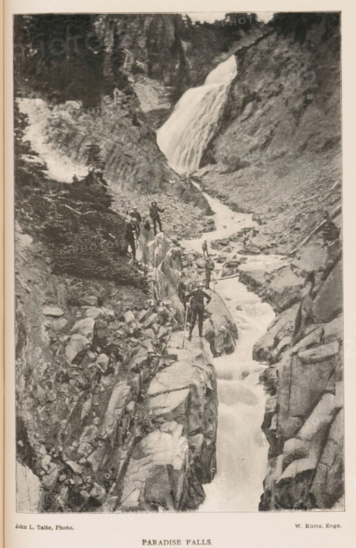 Paradise Falls, View of a group of mountain climbers at a waterfall, page, photomechanical print, photomontage, photographer: John L. Taite, cliché maker: Kurtz, 1887 - 1907, paper, autotype, height 172 mm x width 114 mm, waterfall, mountain climbing, mountaineering, A vertical black-and-white photograph showing a rocky canyon with a waterfall cascading from an upper ledge into a narrow, tumbling stream that flows down between steep rock walls; several people in outdoor clothing and hats stand on narrow rocky ledges and boulders along the stream, some holding walking sticks, while trees and vegetation appear on the higher slopes and ledges surrounding the falls.