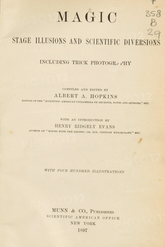 Magic: stage illusions and scientific diversions: including trick photography, comp. and ed. by Albert A. Hopkins, with an intro. by Henry Ridgely Evans, book, annotation: 'MAY, 1996', number: 'L 4010', number: '943', collector's mark: 'Leesmuseum, Amsterdam', writer (clerical worker): Albert A. Hopkins, publisher: Munn and Company, New York (city), 1897, Albert A. Hopkins, Munn and Company, writer (clerical worker), publisher, North America, textile materials, pasteboard, paper, linen (material), printing, wood engraving, autotype, height 248 mm x width 177 mm x thickness 46 mm, A vertically oriented aged book page with a faded cream background and visible paper texture, smudges, and small stains; large dark printed headings near the top and smaller dark printed lines of text arranged in centered blocks down the page; a vertical handwritten annotation in dark pencil at the upper right edge; slight discoloration and a brown spot near the right-center area; evenly spaced margins and a l...