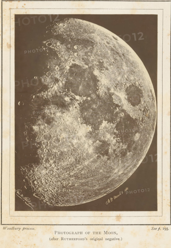 Photograph of the moon, page, photomechanical print, inscription: 'after Rutherford's original negative', inscription: 'Plate I Frontispiece', c. 1870 - in or before 1875, paper, Woodburytype, height 115 mm x width 84 mm, Print opposite title page, moon as celestial body, A sepia-toned rectangular image showing a large, detailed view of a cratered lunar surface set against a dark background, with lighter and darker textured regions, round depressions and raised rims, mottled patterns of rough and smoother areas, and a curved terminator along one edge, all framed by a lighter border that has spots and stains.