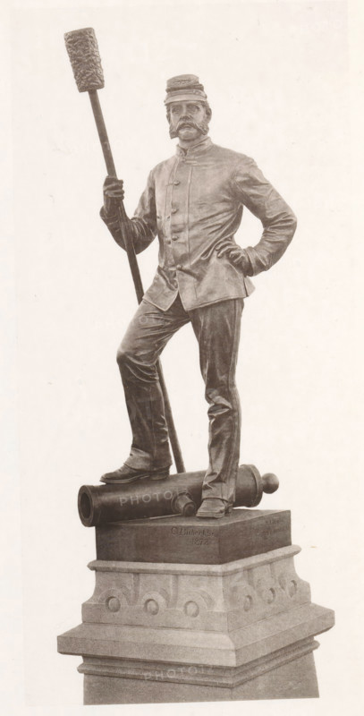 View of a detail of the civil war monument in Manchester, member of the artillery, page, photomechanical print, c. 1875 - in or before 1880, paper, collotype, photoprint, height 192 mm x width 94 mm, Print four pages before page 12., monument, statue, artillery range, firing range, shooting range, military training, A monochrome statue of a man standing on a sculpted pedestal is shown. He wears a uniform jacket with buttons and a cap, and has prominent facial hair. One hand rests on his hip while the other holds a long pole topped with a textured cylindrical object. One foot is placed forward on a cylindrical cannon-like object that lies horizontally on the pedestal. The pedestal has layered stonework with decorative rounded motifs and a stepped base. The statue appears rendered in a realistic style with visible folds in the clothing and detailed facial features.