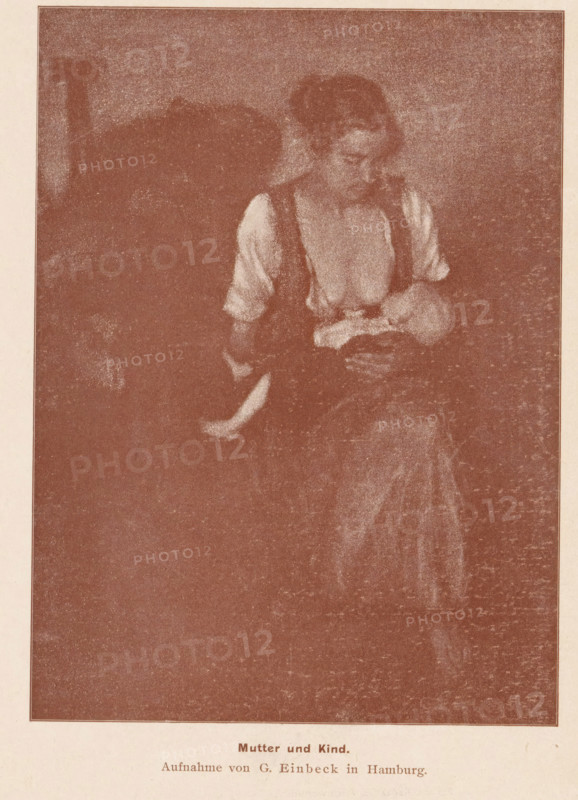 Portrait of an unknown woman with a child at the breast, Mutter und Kind, page, photomechanical print, photographer: George Einbeck, cliché maker: anonymous, printer (person): Wilhelm Knapp Verlag, Halle an der Saale, c. 1893 - in or before 1898, printer (person), Saxony-Anhalt, paper, autotypie, height 164 mm x width 121 mm, Print page opposite 240., mother and baby or young child, A sepia-toned image shows a seated woman holding a small child in her lap; the woman wears a light blouse with darker straps and looks down toward the child, whose head rests near her chest while one small leg extends outward; the background is mostly dark and textured, and the scene is framed with a narrow border.