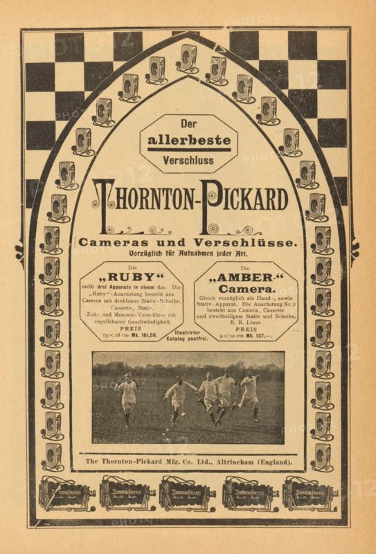 View of a group of running boys, page, photomechanical print, monogram: 'W&H', photographer: unknown, c. 1896 - in or before 1901, paper, autotypie, height 40 mm x width 88 mm, youth, adolescent, running, A vertically oriented vintage advertisement printed on beige paper featuring a large ornamental arch filled with repeated small illustrations of a boxy camera along its inner border, a checkerboard pattern in the upper corners, and a central decorative header with bold stylized lettering. Below the header are two octagonal framed blocks containing smaller printed paragraphs, flanking a central column of decorative flourishes and a horizontal photographic image showing a group of men in light athletic clothing running on a grassy field. The lower section includes a narrow horizontal band with a manufacturer line and a row of detailed camera illustrations across the bottom, all enclosed within a double-lined rectangular frame.