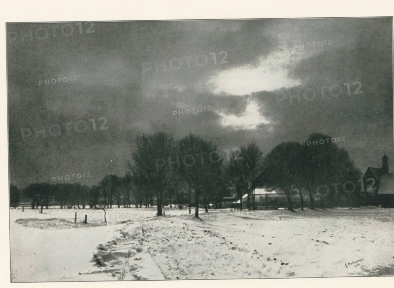 View of a farm in a winter landscape, page, photomechanical print, photographer: Alfred Erdmann, cliché maker: Meisenbach, Riffarth & Cie. (possibly), Berlin, 1902, 1902 - 1903, paper, autotypie, height 140 mm x width 207 mm, farm or solitary house in landscape, snow, A snowy landscape with a broad foreground of snow-covered ground and a rough path leading toward a line of tall leafless trees; behind the trees a low building with a sloped roof is partially visible and a taller structure with a pointed roof rises to one side; the sky above is dark and cloudy with a bright irregular cloud area near the center that contrasts with the surrounding darker clouds.