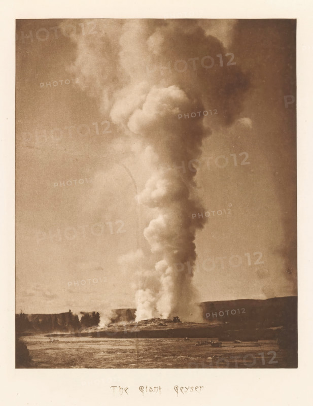 The Giant Geyser, page, photomechanical print, photographer: Frank Jay Haynes, Yellowstone National Park, cliché maker: The Photo-gravure Co., New York (city), c. 1882 - in or before 1887, North America, paper, photoaquatint, height 207 mm x width 165 mm, hot spring, geyser, Giant Geyser, A tall column of light-colored steam rises from a ground opening and extends upward through the sky, forming billowing rounded clouds that widen and diffuse near the top; the steam contrasts with a darker sky and stands above a flat landscape with a tree-lined horizon, scattered low vegetation, and a foreground area of textured ground.