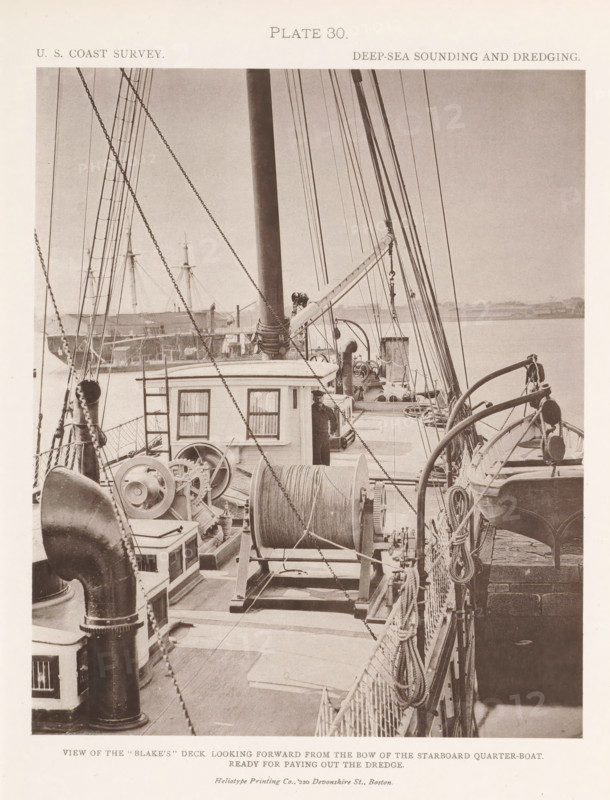 View of the deck of the George S. Blake, page, photomechanical print, name: 'Heliotype Printing Co., 220 Devonshire St., Boston.', inscription: 'View of the 'Blake's' deck looking forward from the bow of the starboard quarter-boat. Ready for paying out the dredge.', number: 'Plate 30.', United States of America, printer (person): Heliotype Printing Company, Boston (Massachusetts), c. 1870 - in or before 1880, Heliotype Printing Company, printer (person), North America, Massachusetts, paper, collotype, photoprint, height 200 mm x width 165 mm, ships (in general), A sepia-toned photograph showing the deck of a ship with a central mast, rigging, and multiple ropes and chains running vertically and diagonally across the frame, a large spool of cable mounted on a wooden cradle near the center, mechanical winches and pulleys, a small deckhouse with curtained windows, coiled ropes and fenders along the rail, davits holding a boat secured on the starboard side, metal vents and chimneys, a crew...