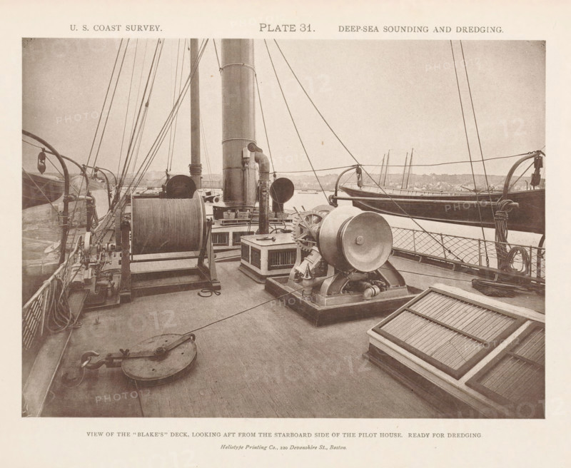 View of the deck of the George S. Blake, page, photomechanical print, name: 'Heliotype Printing Co., 220 Devonshire St., Boston.', inscription: 'View of the 'Blake's' deck, looking aft from the starboard side of the pilot house. Ready for dredging.', number: 'Plate 31.', United States of America, printer (person): Heliotype Printing Company, Boston (Massachusetts), c. 1870 - in or before 1880, Heliotype Printing Company, printer (person), North America, Massachusetts, paper, collotype, photoprint, height 160 mm x width 221 mm, ships (in general), A sepia-toned photograph showing the deck of a ship with wooden planks, large cylindrical winches and drums, gears and metal machinery mounted on bases, vertical smokestacks rising from the deck, coils of rope and nets stowed along the rail, rigging lines and stays running upward and across the frame, davits holding a lifeboat alongside the rail, a framed hatch with slatted cover on the deck, a block and tackle fitting and various pulleys, and...