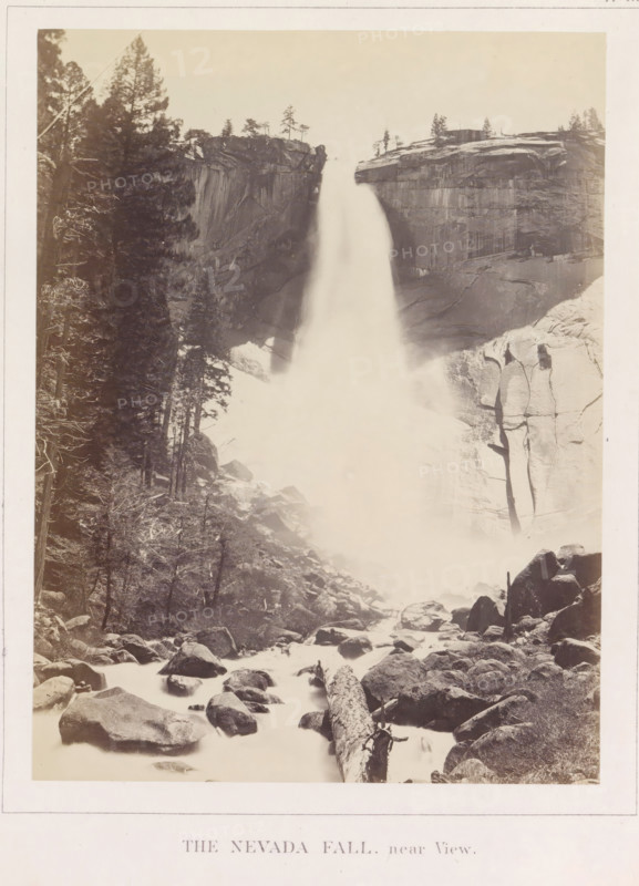 The Nevada Fall near View, View of the Nevada Falls in the Yosemite Valley, photograph, page, number: 'XVIII.', photographer: Carleton E. Watkins, Yosemite Valley, c. 1860 - in or before 1868, North America, California, paper, albumen print, height 206 mm x width 155 mm, waterfall, mountains, rock-formations, dale, valley, Nevadawaterval, A tall waterfall plunges between steep rocky cliffs, creating a misty plume that flows down into a boulder-strewn riverbed; dense evergreen trees line the left side of the scene and clinging trees dot the cliff tops, while large rounded rocks and a fallen log lie in the foreground among the flowing water.
