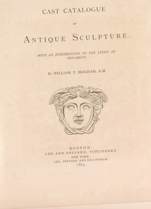 Cast catalog of antique sculpture with an introduction to the study of ornament, book, publisher: Lee and Shepard, Boston (Massachusetts), publisher: Lee, Shepard, and Dillingham, New York (city), 1874, North America, Massachusetts, textile materials, pasteboard, paper, linen (material), albumen print, height 305 mm x width 250 mm x thickness 20 mm, A faded page with a centered decorative title layout on a light beige background, featuring a large classical-style engraved face with stylized wavy hair and winged elements above the forehead, surrounded by ornamental lines, and several lines of printed text above and below the engraving in a dark serif type.