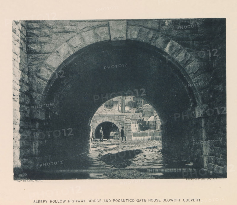 Sleepy Hollow Highway Bridge and Pocantico Gate House blowoff culvert, page, photomechanical print, photographer: P. de Luze, New York, cliché maker: The Photo-gravure Co., c. 1883 - in or before 1887, North America, paper, collotype, photoprint, height 153 mm x width 202 mm, bridge, A dark stone archway frames a view of another smaller stone arch and a cascading stepped water feature, with rough stone walls on either side and a shallow streambed leading inward; two figures stand near the inner arch, one holding a long object, and nearby are scattered stones and construction materials with timber scaffolding visible above the cascade.