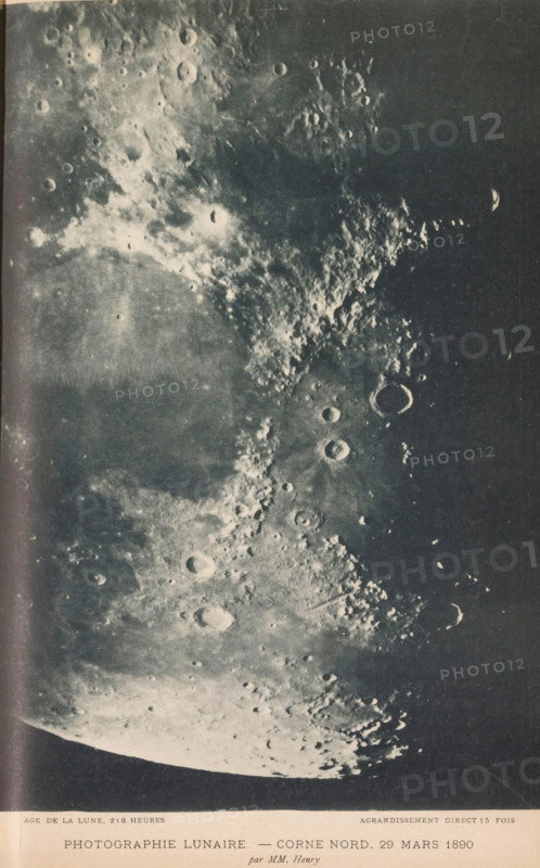 View of part of the moon's surface, Photographie lunaire - corne nord. 29 mars 1890, page, photomechanical print, inscription: 'age de la lune, 216 heures agrandissement direct 15 fois', photographer: Paul-Pierre Henry, France, cliché maker: Michel Berthaud, 1890-03-29, Paul-Pierre Henry, Michel Berthaud, photographer, cliché maker, paper, collotype, photoprint, height 224 mm x width 158mm, surface of the moon, A grayscale close-up photograph of a cratered lunar surface showing a wide expanse of overlapping circular depressions and raised rims, with rough, textured regions of ejecta and bright highlights contrasting darker smooth plains; the image includes varied crater sizes, sharp shadows inside many rims, scattered small bright spots, and a curved limb of the lunar disk at the lower edge.