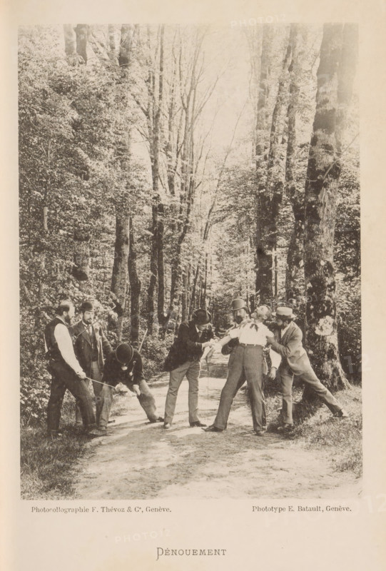 Dénouement, A group of unknown men, one of whom is being held and probably has a wound on the arm bandaged, page, photomechanical print, maker: F. Thévoz & Cie., maker: E. Batault, c. 1888 - in or before 1893, paper, collotype, photoprint, height 162 mm x width 116 mm, lighting, lamps, saber (, fencing), edifice, eg: public building, department store - AA - civic architecture: inside, A sepia-toned photograph shows a wooded path lined with tall trees and dense foliage on both sides, with sunlight filtering through the branches; on the path a group of men in period clothing are engaged in a physical struggle, some wearing hats and jackets, with one man leaning back as others grip his arms and clothing while another appears to be crouching and holding a stick or pole near the ground; the men display varied postures and focused expressions, and the scene occupies the lower portion of the image while the tall trees dominate the upper portion.