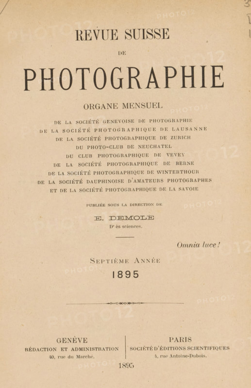 Revue suisse de photographie, Société genevoise de photographie ... et al., book, number: '194', annotation: 'Je. van Severen, Ruysselede', editor (person who revises): Eugène Demole, 1895, editor (person who revises), biological material, paper, leather, printing, collotype, photoaquatint, autotypie, agate marbled paper, scrotel marbled paper, height 230 mm x width 164 mm x thickness 27 mm, The image shows an aged, beige paper page with printed dark serif typography arranged in centered lines and blocks across the surface, including a large bold word near the top and smaller lines of evenly spaced words beneath, a decorative thin horizontal ornament near the middle, and two columns of text separated by a vertical rule toward the lower portion; the paper has a slightly mottled texture with small speckles and faint discoloration.